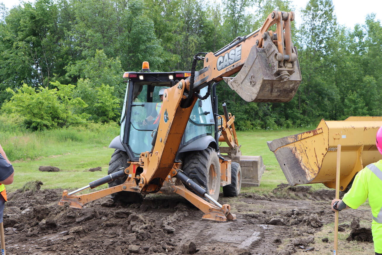 A student uses a min excavator during a training session in 2022.